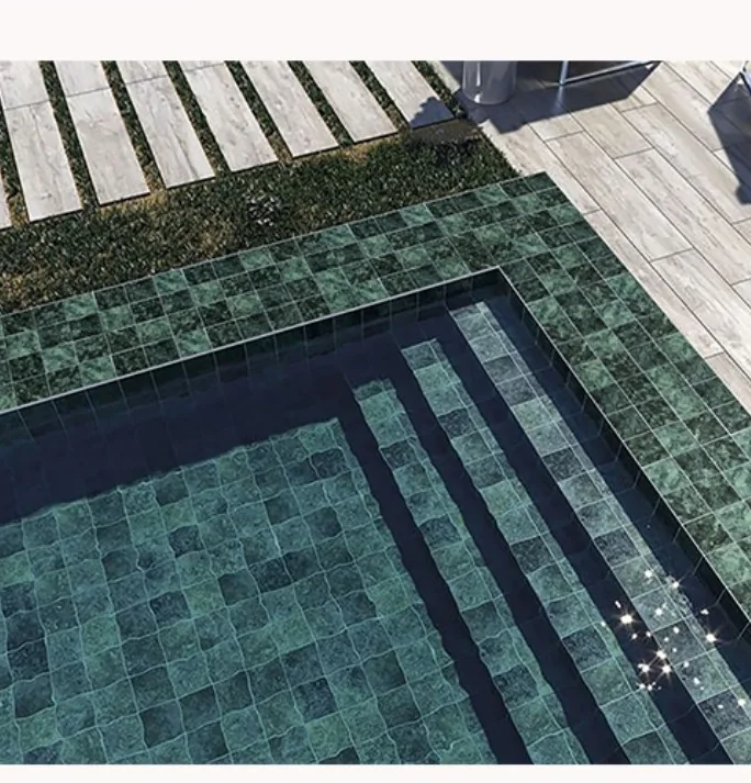 Green 97 by 97 millimetre tiles lining a swimming pool and steps